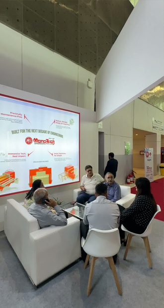 Industrial machinery manufacturer MonoTech Engineers Pvt Ltd booth meeting area featuring a product value wall display.